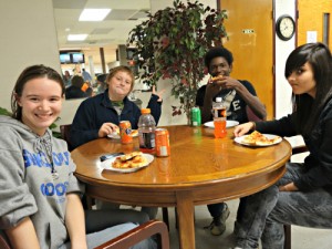 CIS students enjoy pizza during a weekend bowling outing at the J. Smith Young YMCA earlier this school year.